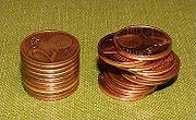 A stack of coins stacked evenly, and a stack of the same number of coins stacked unevenly.